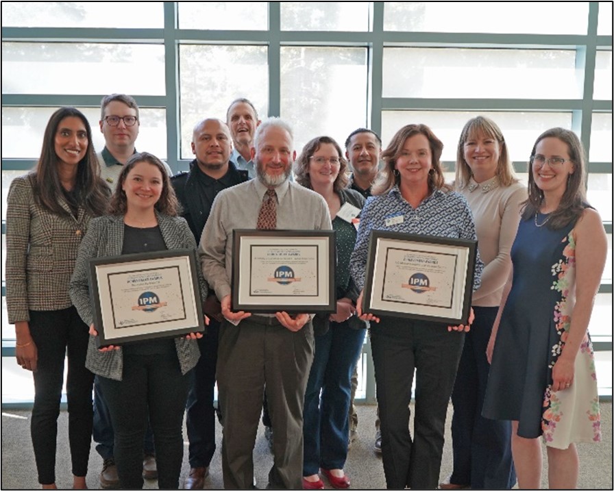 All 2025 IPM Achievement Awards posing for a photo with DPR Director Karen Morrison and Deputy Director Sapna Thottathil.